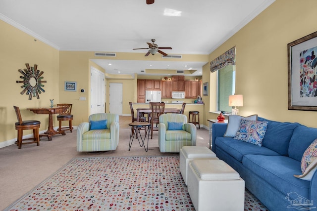 living room with ornamental molding, light carpet, and ceiling fan