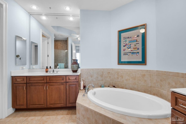 bathroom featuring vanity, ceiling fan, tile patterned flooring, and plus walk in shower