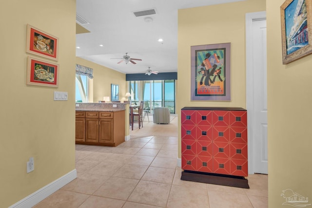 hall featuring light tile patterned flooring and a wealth of natural light