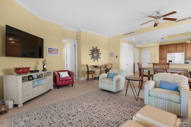 carpeted living room with ornamental molding and ceiling fan