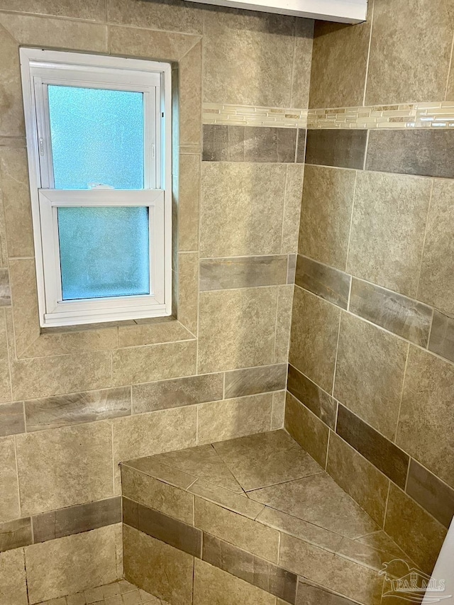 full bathroom featuring tiled shower