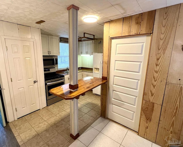 kitchen with light tile patterned floors and stainless steel appliances