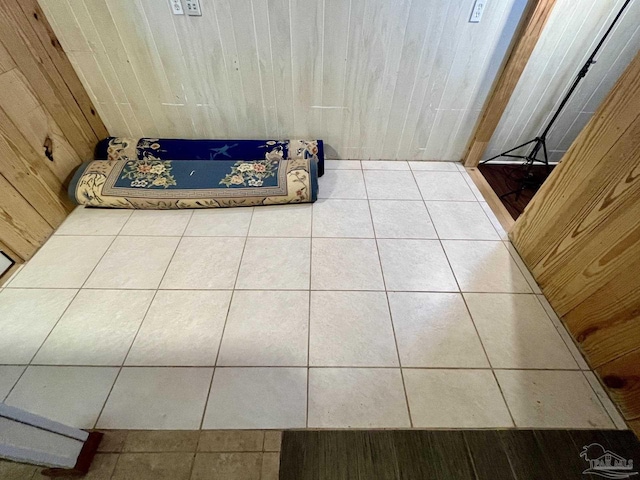 bathroom with wooden walls and tile patterned floors