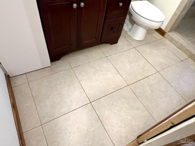 bathroom with toilet and tile patterned floors