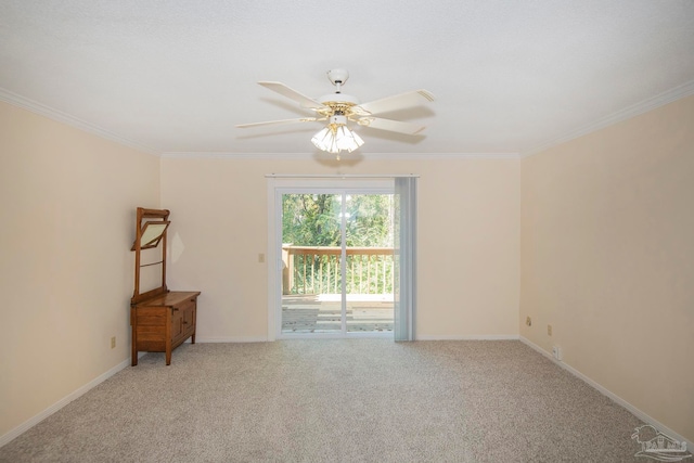 carpeted spare room featuring ornamental molding and ceiling fan