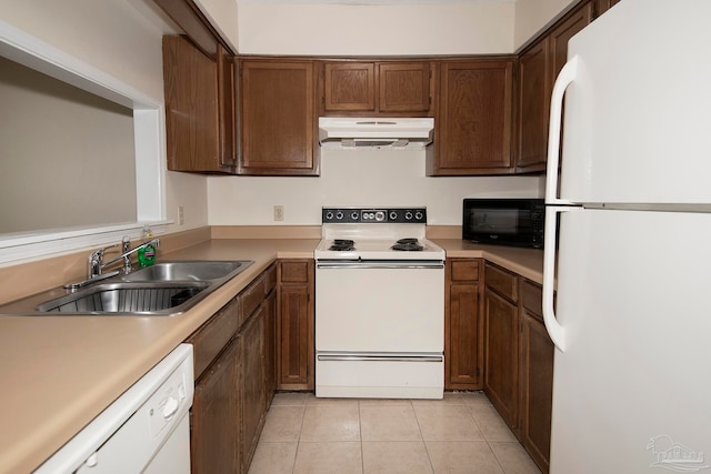 kitchen featuring light tile patterned floors, white appliances, and sink