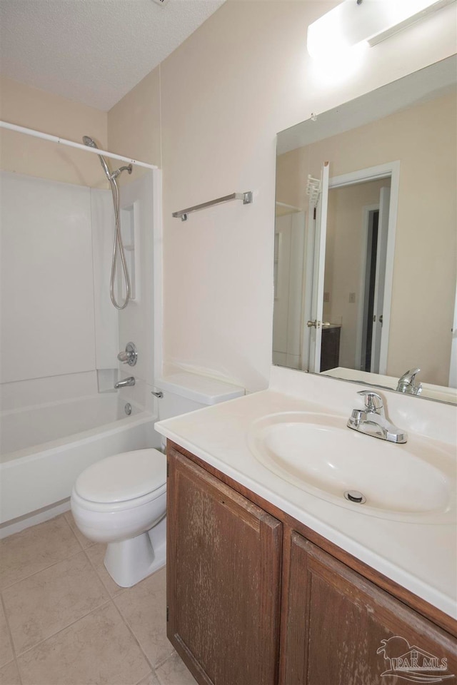 full bathroom featuring tile patterned floors, toilet, washtub / shower combination, a textured ceiling, and vanity