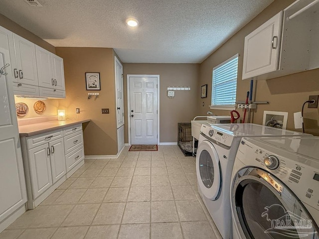 5020 Lantana Dr, Gulf Breeze, FL 32563 - washroom featuring independent washer and dryer, cabinet space, a textured ceiling, baseboards, and light tile patterned floors