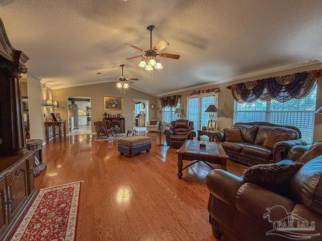 5020 Lantana Dr, Gulf Breeze, FL 32563 - living area featuring ceiling fan, wood finished floors, crown molding, a textured ceiling, and lofted ceiling