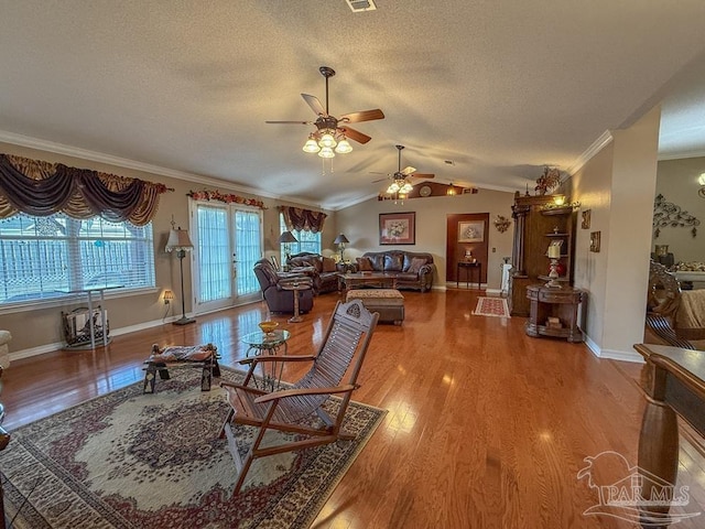 5020 Lantana Dr, Gulf Breeze, FL 32563 - living room with ornamental molding, a ceiling fan, a textured ceiling, wood finished floors, and lofted ceiling