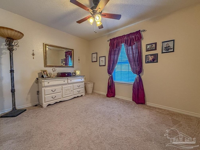 5020 Lantana Dr, Gulf Breeze, FL 32563 - bedroom featuring a textured ceiling, light colored carpet, baseboards, and a ceiling fan