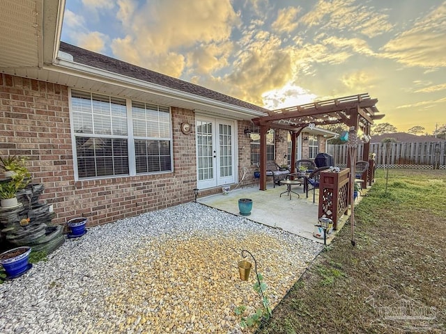 5020 Lantana Dr, Gulf Breeze, FL 32563 - patio terrace at dusk featuring a pergola, french doors, and fence