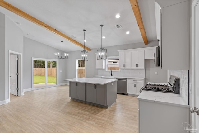 kitchen with a kitchen island, pendant lighting, dishwasher, white cabinets, and stove