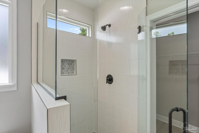 bathroom with a shower with shower door