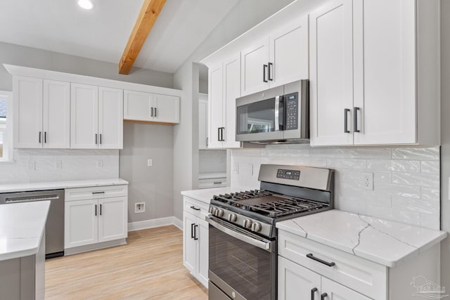 kitchen with light hardwood / wood-style flooring, white cabinetry, beam ceiling, stainless steel appliances, and light stone counters