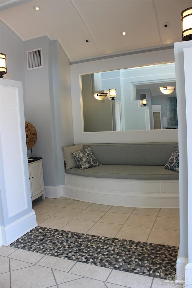 bathroom with vanity, lofted ceiling, and tile patterned floors