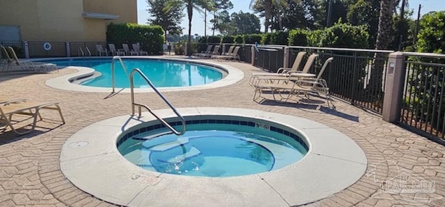 view of pool featuring a community hot tub and a patio area