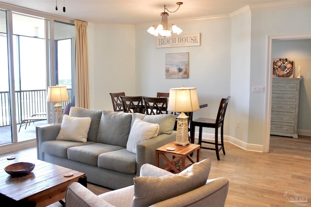 living room featuring a chandelier, light wood-type flooring, and crown molding