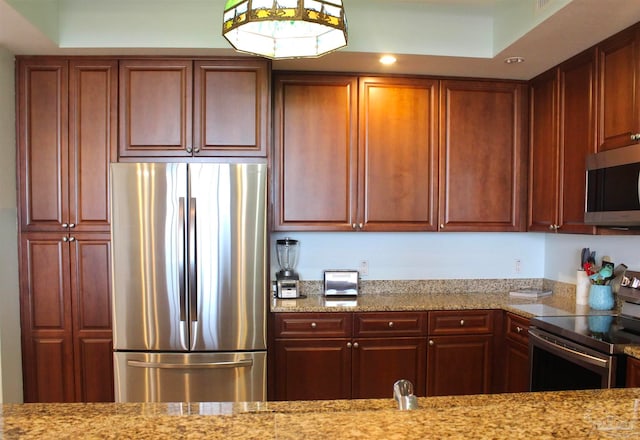 kitchen featuring appliances with stainless steel finishes and light stone countertops