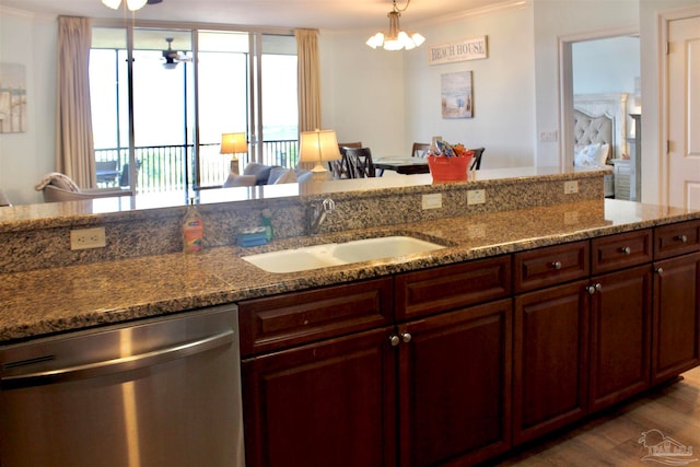 kitchen featuring stainless steel dishwasher, sink, hardwood / wood-style flooring, and stone countertops