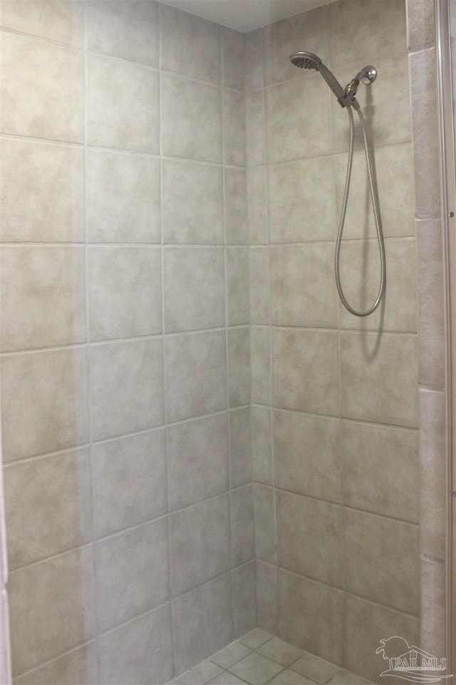 bathroom with a tile shower