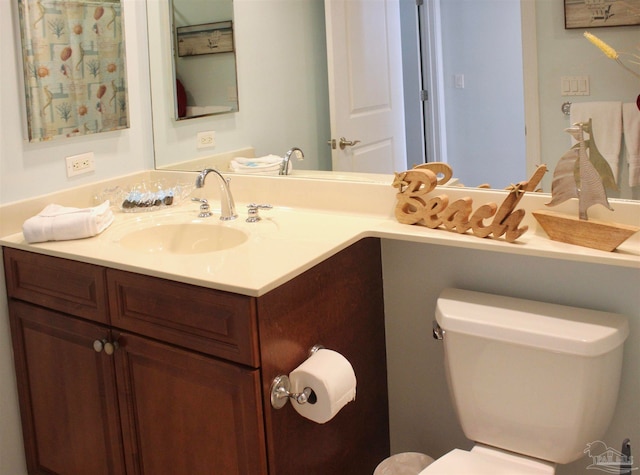 bathroom featuring vanity and toilet