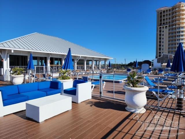 deck with an outdoor hangout area and a community pool