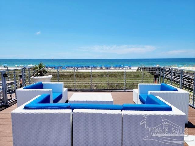 view of patio / terrace with a balcony, an outdoor living space, and a water view