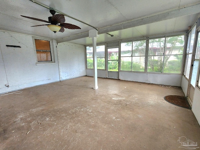 unfurnished sunroom featuring plenty of natural light and ceiling fan