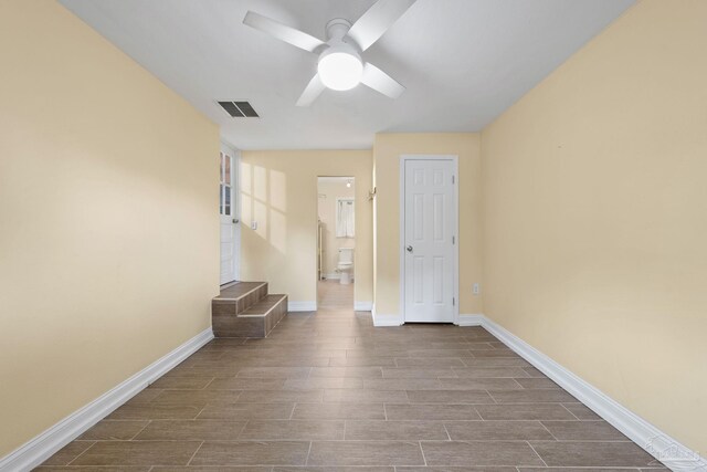 empty room featuring brick wall, crown molding, and wood-type flooring