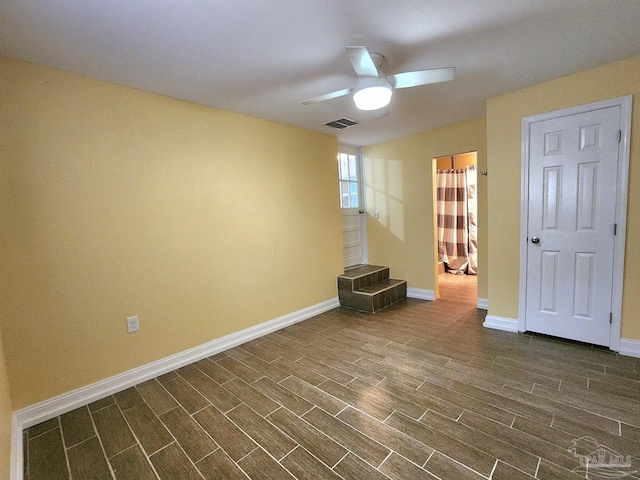 unfurnished room featuring ceiling fan and dark hardwood / wood-style floors