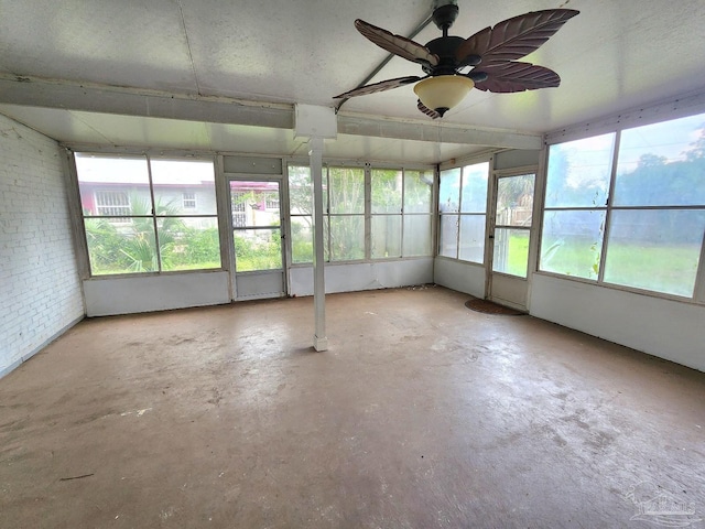 unfurnished sunroom with ceiling fan