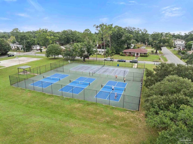 view of tennis court with a yard