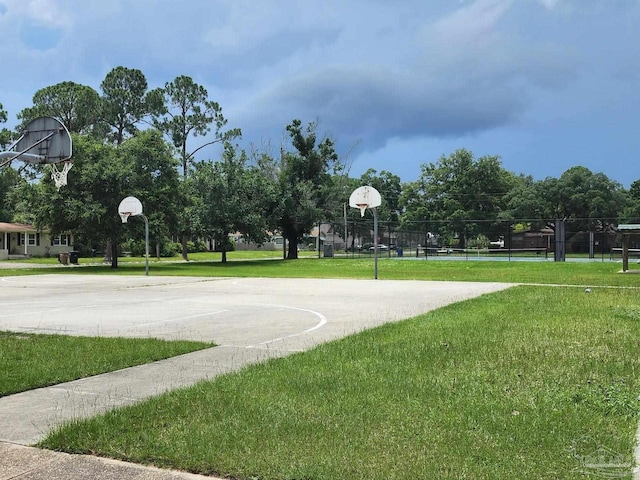 view of sport court featuring a lawn