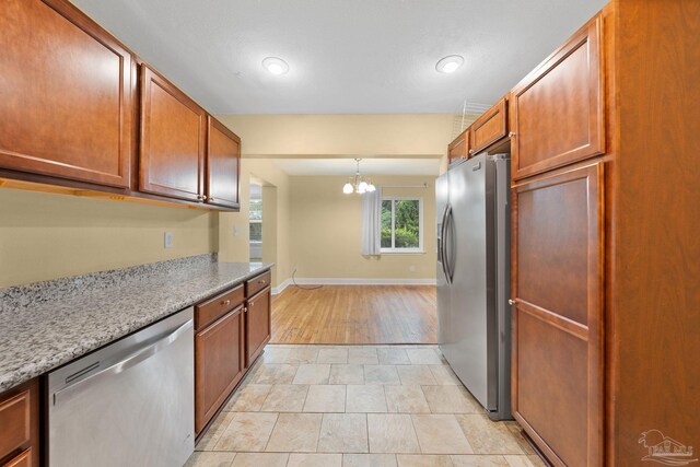 kitchen with light hardwood / wood-style floors, decorative light fixtures, an inviting chandelier, stainless steel refrigerator with ice dispenser, and dark brown cabinetry