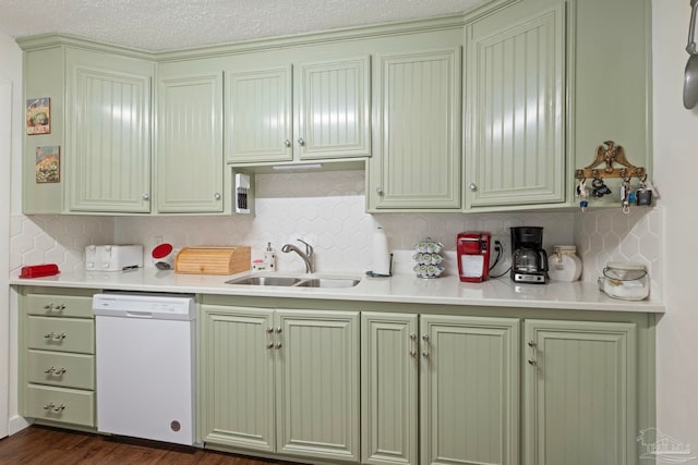 kitchen with dark wood-type flooring, tasteful backsplash, white dishwasher, and sink