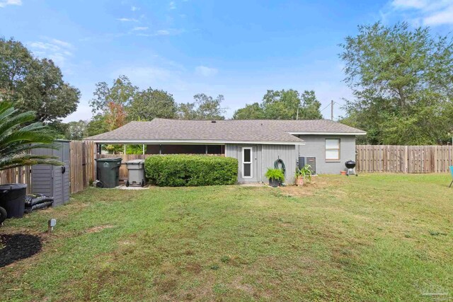 rear view of house with a lawn