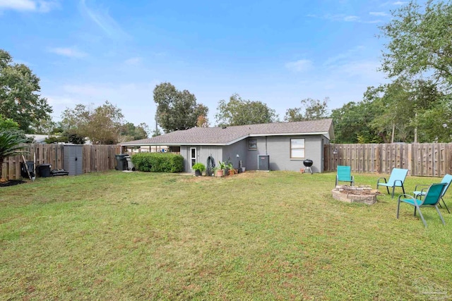 view of yard with cooling unit and a fire pit