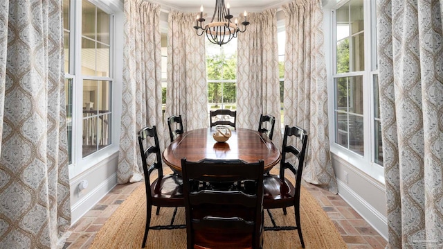 dining area featuring an inviting chandelier and crown molding