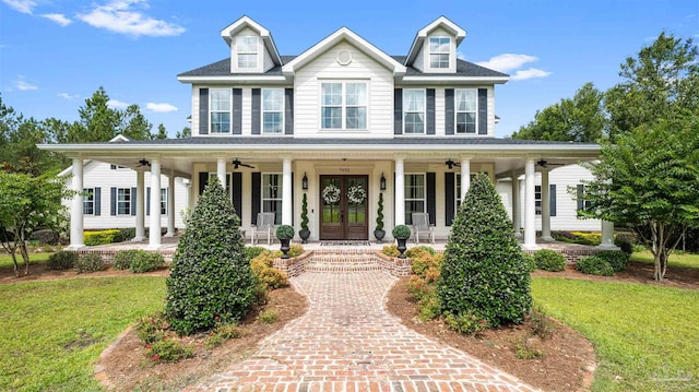 view of front facade with a front lawn, ceiling fan, and a porch