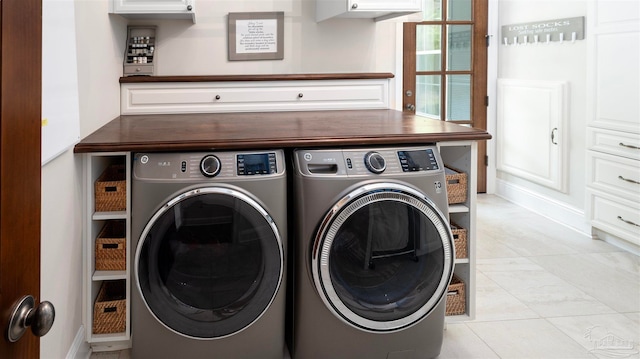 laundry area featuring light tile patterned floors and independent washer and dryer