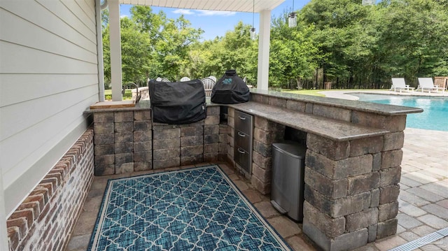 view of patio / terrace with a fenced in pool and a bar