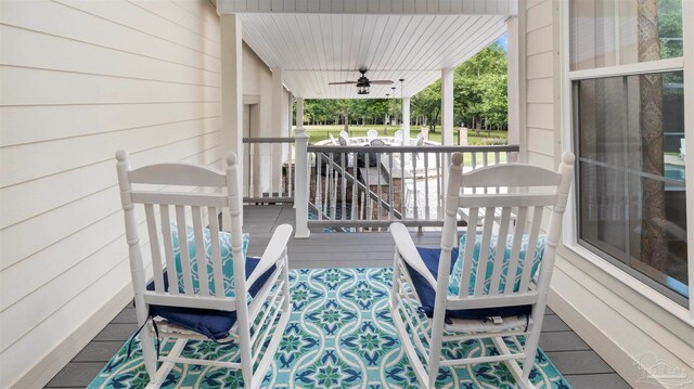 wooden terrace featuring ceiling fan and a porch