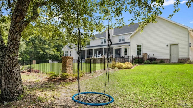 rear view of property with a yard