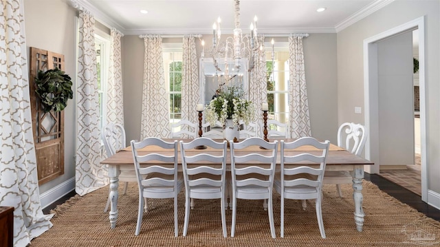 dining area with dark wood-type flooring, crown molding, and a notable chandelier