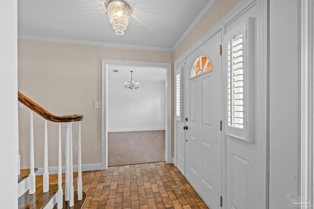 foyer featuring crown molding and a notable chandelier