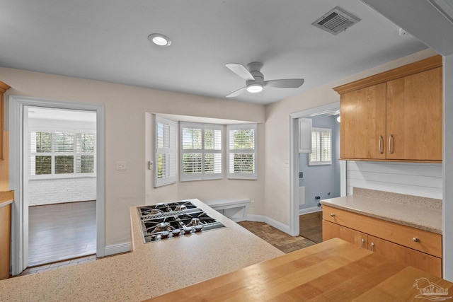 kitchen with wooden counters, stainless steel gas cooktop, ceiling fan, and light wood-type flooring