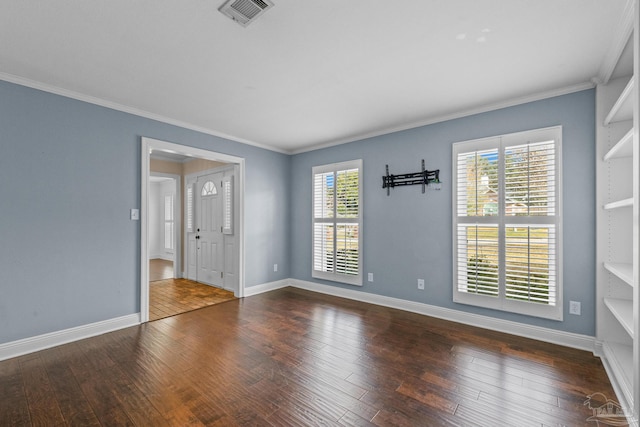 empty room featuring crown molding and dark hardwood / wood-style flooring