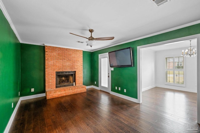 unfurnished living room with crown molding, ceiling fan with notable chandelier, hardwood / wood-style floors, and a brick fireplace