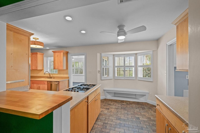 kitchen with sink, ceiling fan, butcher block counters, stainless steel appliances, and light brown cabinetry